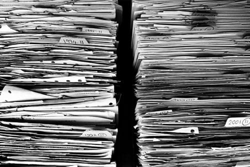 stacks of papers to file when dealing with insurance companies